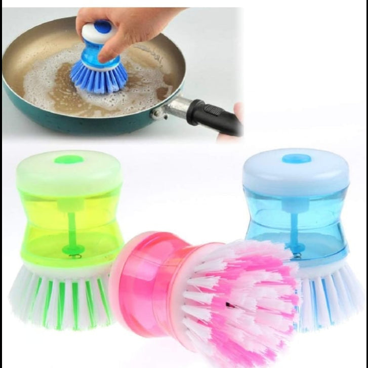 Colorful dish scrubber brushes with a hand washing a pan.